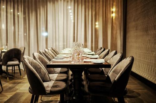 a long table in a room with chairs and wine glasses at Hotel X Brisbane Fortitude Vly, Vignette Collection by IHG in Brisbane