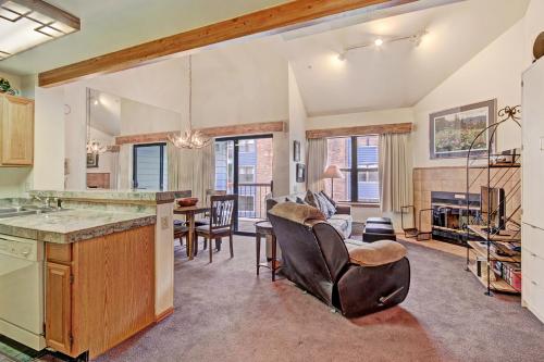 a kitchen and living room with a table and chairs at Studio Apartment in Breckenridge