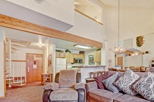a living room with a couch and chairs and a kitchen at Studio Apartment in Breckenridge