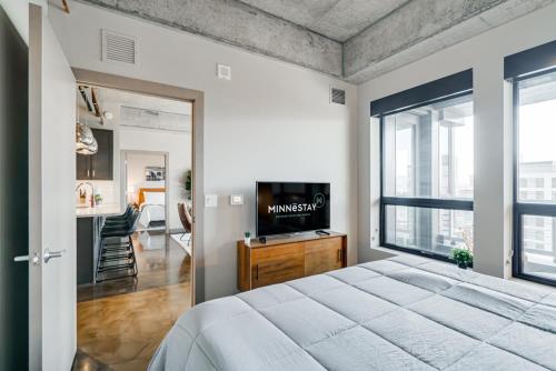 a bedroom with a large bed and a large window at Sable 75 - Two Bedroom in Minneapolis