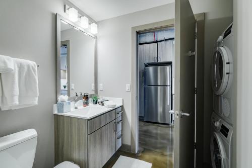 a bathroom with a sink and a refrigerator at Sable 48 in Minneapolis