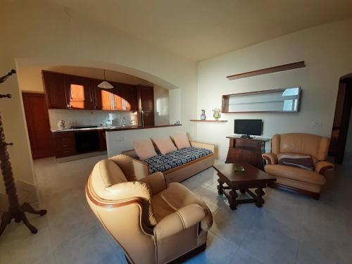 ein Wohnzimmer mit einem Sofa und 2 Stühlen in der Unterkunft Le Cortine in Roccatederighi
