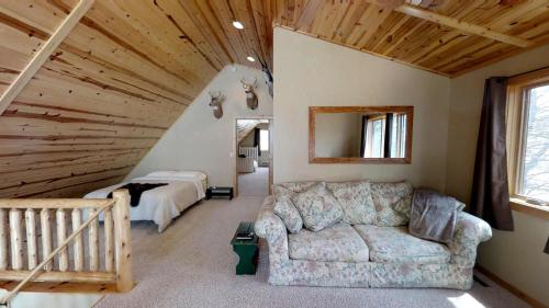 a living room with a couch and a bedroom at Lakefront Hideaway in Litchfield