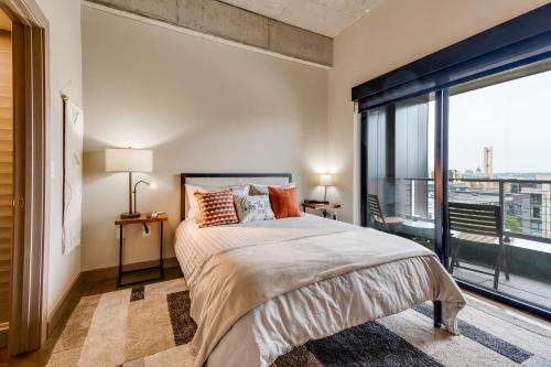 a bedroom with a large bed and a large window at Sable 85 - Two Bedroom in Minneapolis