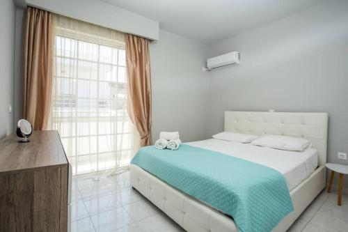a bedroom with a bed and a large window at Pelagias apartments in Rhodes Town