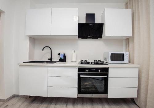 Kuchyň nebo kuchyňský kout v ubytování CooZee Apartment