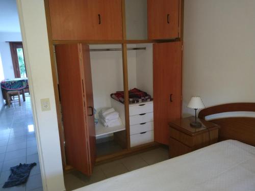 a bedroom with a closet with a bed and a mirror at Gracyal in Chascomús
