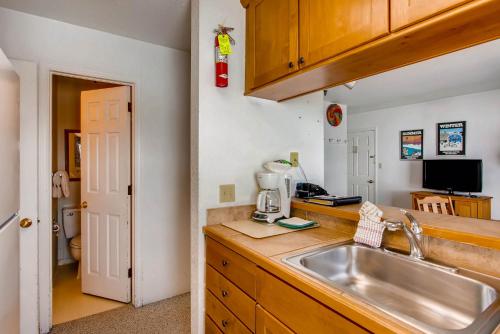 a kitchen with a sink and a counter top at View Of Mt Crested Butte- 1 Br Condo in Crested Butte