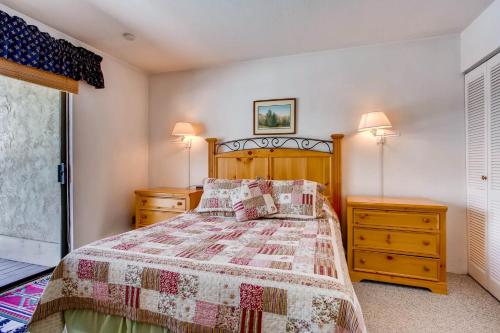 a bedroom with a bed and two night stands at View Of Mt Crested Butte- 1 Br Condo in Crested Butte