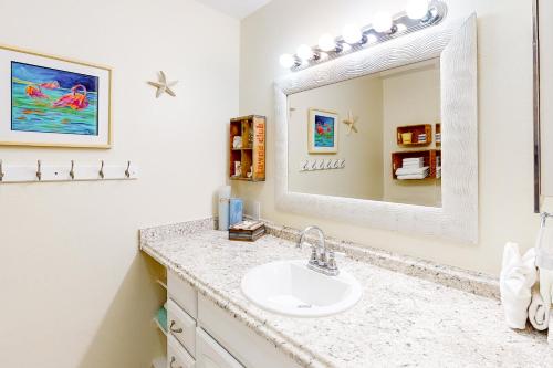 a bathroom with a sink and a mirror at Bermuda Bay Beach & Racquet Club, Unit E in St Petersburg