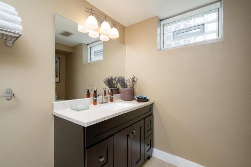 a bathroom with a sink and a mirror at Linden Hills Retreat in Minneapolis