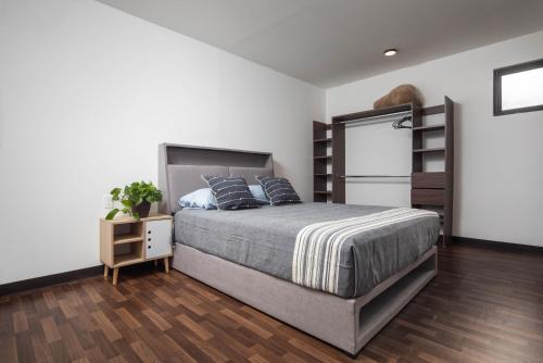 a bedroom with a bed and a book shelf at EXPERIENCE in Pescadero