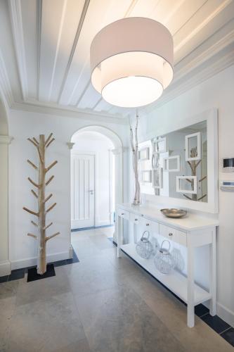 a room with a white table and a tree in it at Shantivillas Malhão in Azinhal
