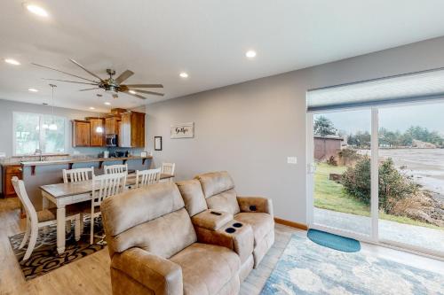 a living room with a couch and a table at Sunset Beach House in Coos Bay