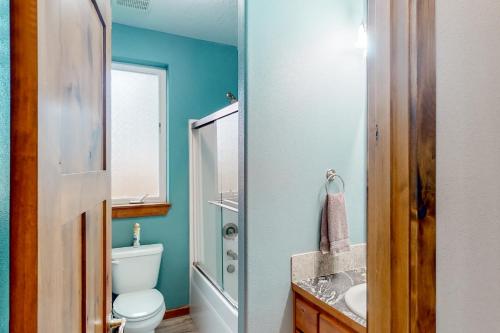a bathroom with a toilet and a sink at Sunset Beach House in Coos Bay