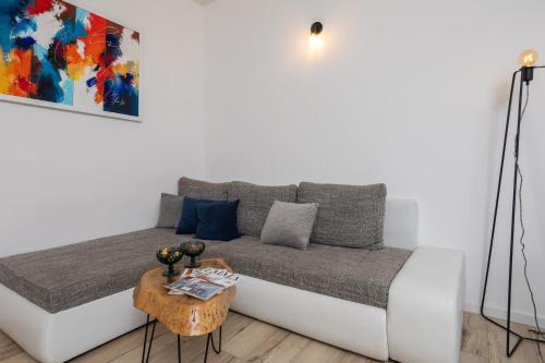 a couch in a living room with a table at Split City App - Private Parking & Terrace in Split