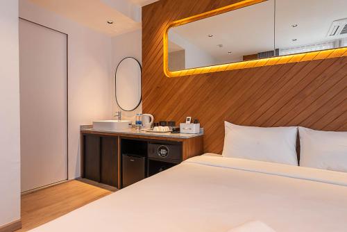 a hotel room with a bed and a sink at Boxpackers Pratunam in Bangkok