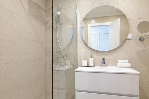a bathroom with a sink and a mirror at Sea Lovers - Sea front - studio apartment in Monte Gordo