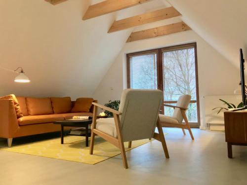 a living room with a couch and a table at Moorblick! Große Dachwohnung mit Kamin und Sauna in Leck