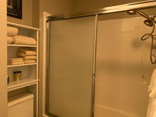 a shower with a glass door in a bathroom at Telemark #4 Townhouse On The River in Red River