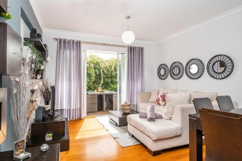 a living room with a couch and a table at Home to Stay by Homie in Funchal