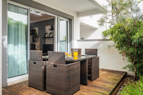 an outdoor dining area with a table and chairs at Home to Stay by Homie in Funchal
