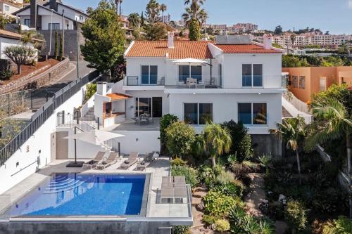 an aerial view of a house with a swimming pool at OurMadeira - Villa Aquarela, panoramic seaviews in Caniço