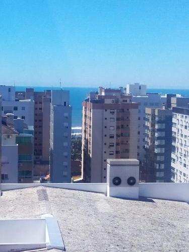 a view of a city from the roof of a building at Ap 2 dormitórios com piscina a 4 quadras do mar Le Monde in Capão da Canoa