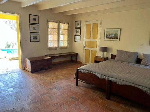 a bedroom with a bed and a table and a window at Principauté in Gorée
