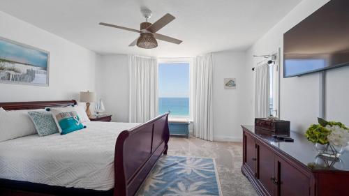 a bedroom with a bed with a view of the ocean at Emerald Beach #1331 by Nautical Properties Vacation Rentals in Panama City Beach