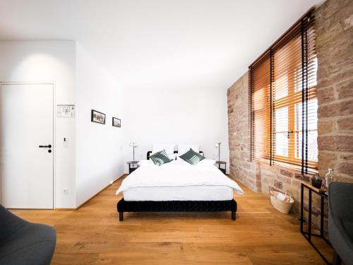 a bedroom with a bed and a brick wall at Alte Schule Tiefenbach in Tiefenbach