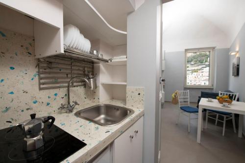 a kitchen with a sink and a counter top at Vittoria House Centro Storico in Amalfi