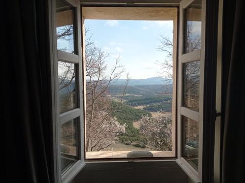 an open window with a view of a valley at La Fontaine in Bargème