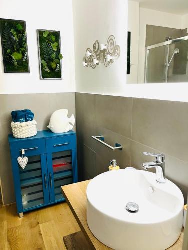 a bathroom with a white sink and a blue cabinet at Rolli De Mar - il tuo appartamento Rolli nel cuore di Genova, Acquario e Porto Antico in Genoa