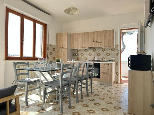 a kitchen with a table and chairs in a room at Appartamento Mare Fuori a Vada by Zoom In Earth in Vada