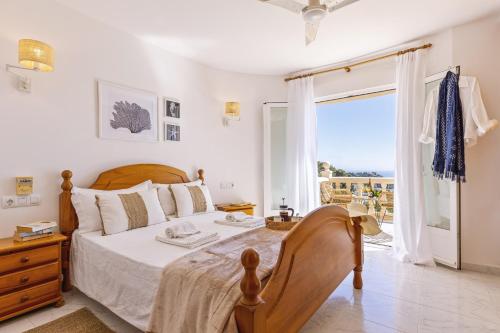 a bedroom with a bed and a large window at Casa Thalassa in Balcon del Mar