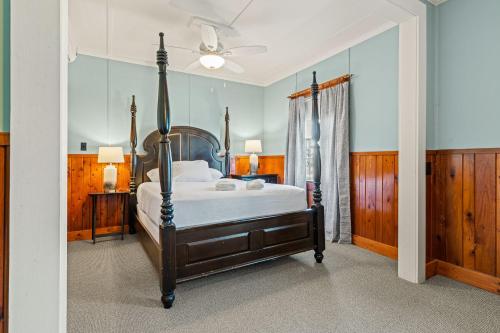 a bedroom with a bed and a ceiling fan at Nags Head Beach Inn by KEES Vacations in Nags Head