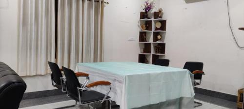 a room with a table and chairs and a couch at Iranyai Homestay in Imphal