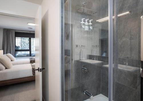 a bathroom with a shower and a toilet and a sink at Peaks and Birdies by Revelstoke Vacations in Revelstoke