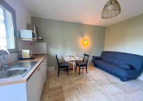 un salon avec un canapé bleu et une table dans l'établissement Sweet Home, à Antibes