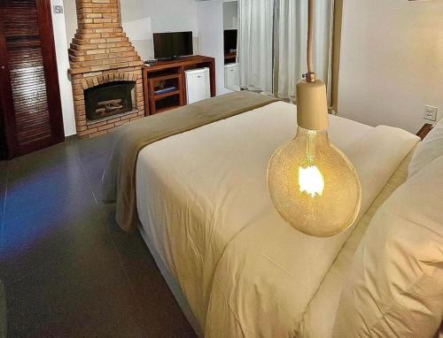 a bedroom with a bed with a fire place at Hotel Bertell in Penedo
