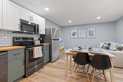a kitchen with a table and chairs and a kitchen with a couch at Elegant Boho Retreat - 8 min to WEM in Edmonton