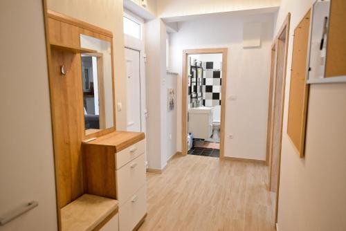 a hallway with white walls and wood floors at Apartment Rocky II in Zadar