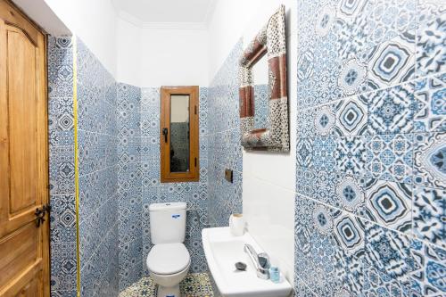 a bathroom with a toilet and a sink at Riad imNane Lodge in Tamguist