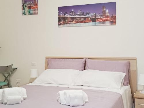 a bedroom with a bed with two towels on it at B&B da Niky in Termoli