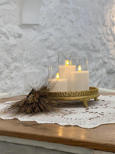 a candle sitting on top of a wooden table at Dimora L’Antico Bijou in Ostuni