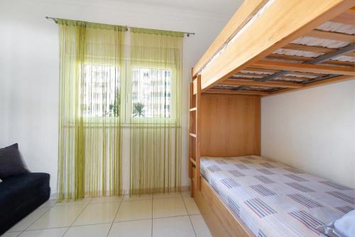 a bedroom with a bunk bed and a window at Marina In Sight in Portimão