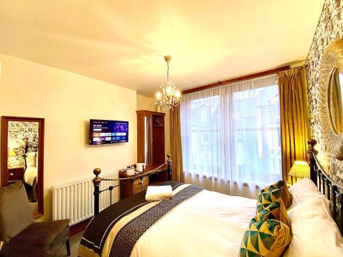 a bedroom with a bed and a large window at Elm Tree Lodge in Keswick