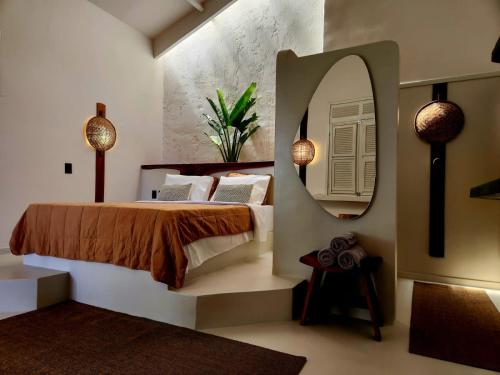 a bedroom with a large bed and a mirror at Outro Beach Hotel Cumbuco in Cumbuco