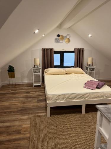 a bedroom with a bed and a large window at Villa Serenity in Balchik